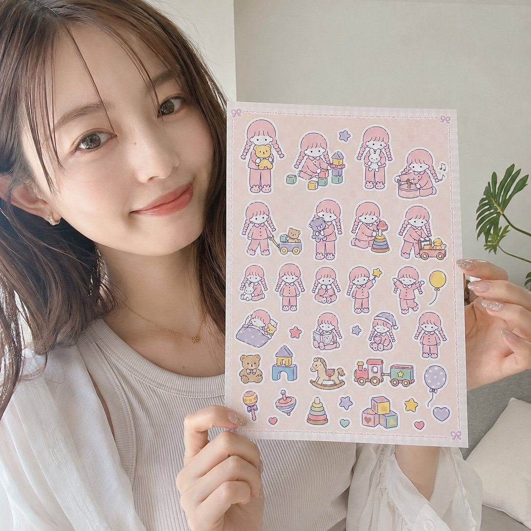女性がピンク色のオリジナルシールシートを手に持っている完成イメージ